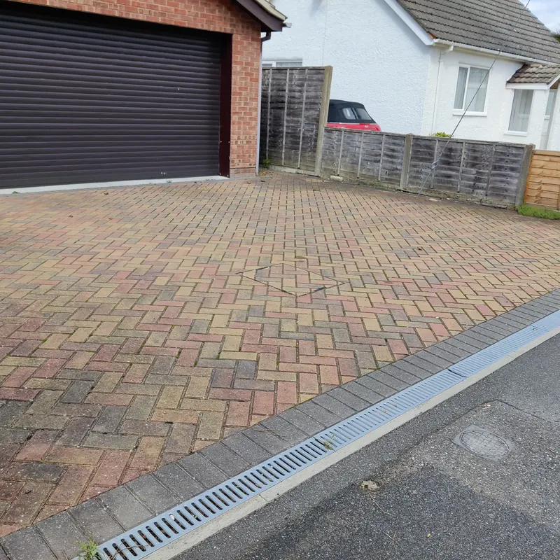 Herringbone block paving driveway in front of a garage
