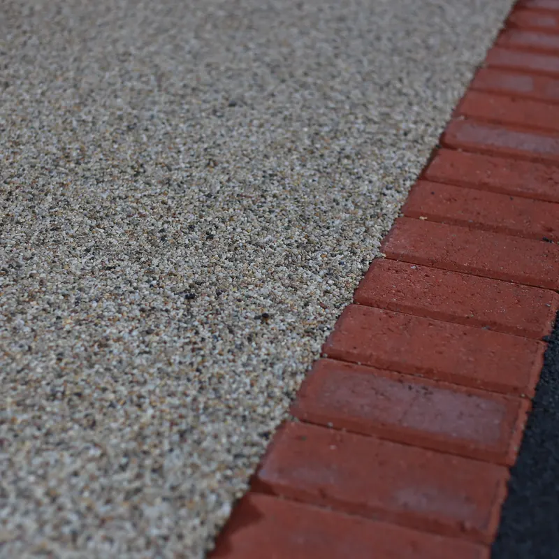 Resin bound driveway surface with a red block border