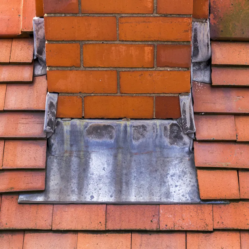Chimney stack with lead flashing on a tiled roof